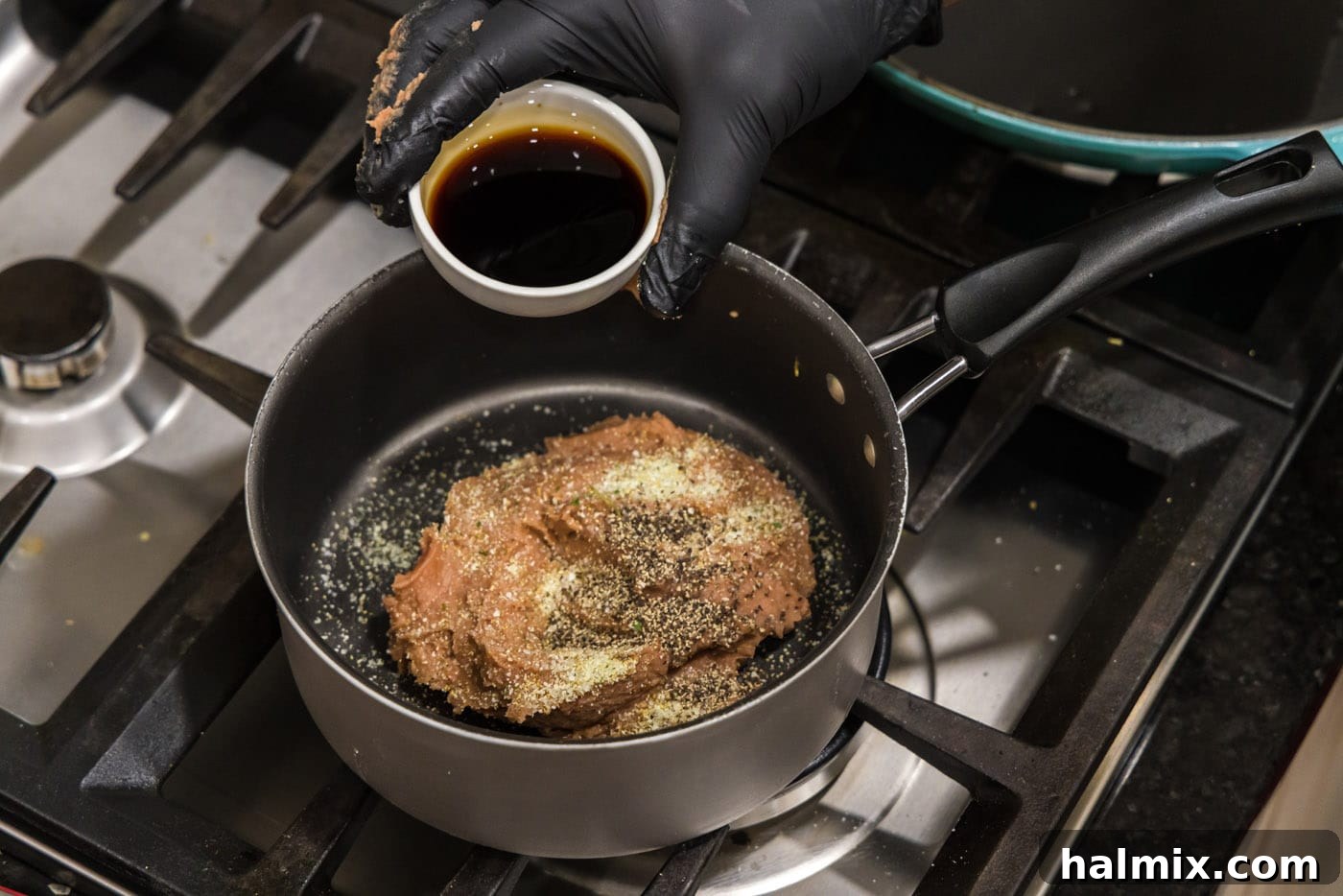 Deep-Fried Mexican Delights 6 adding soy sauce to refried beans in a saucepan with seasonings, preparing the bean mixture