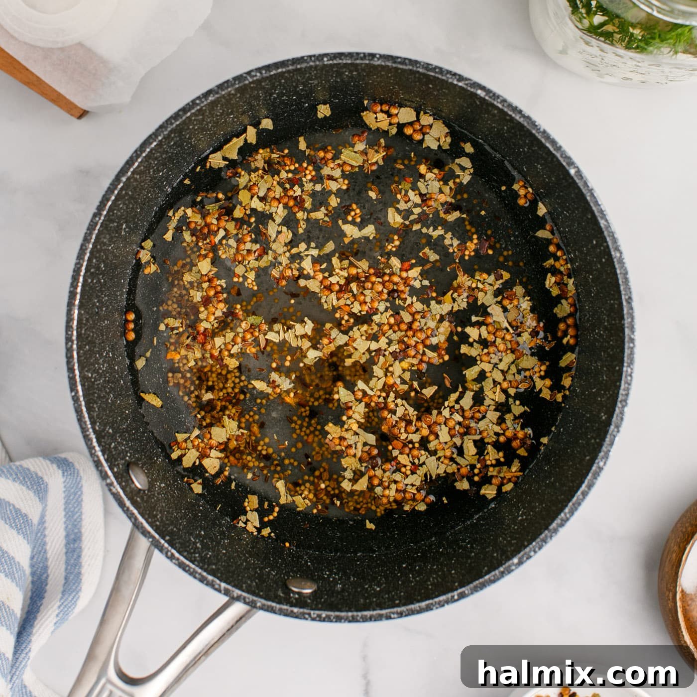 pickling spices added to vinegar in a saucepan