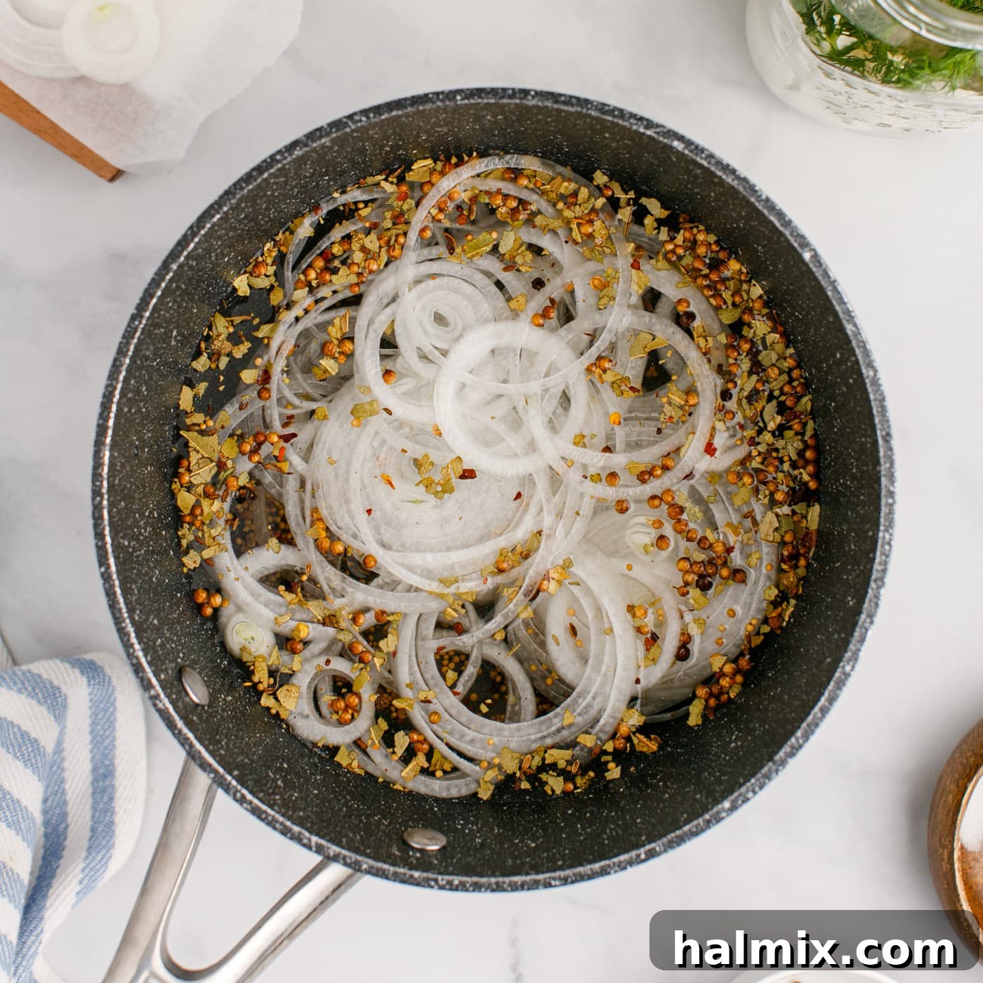 sliced onion added to saucepan with pickled eggs brine