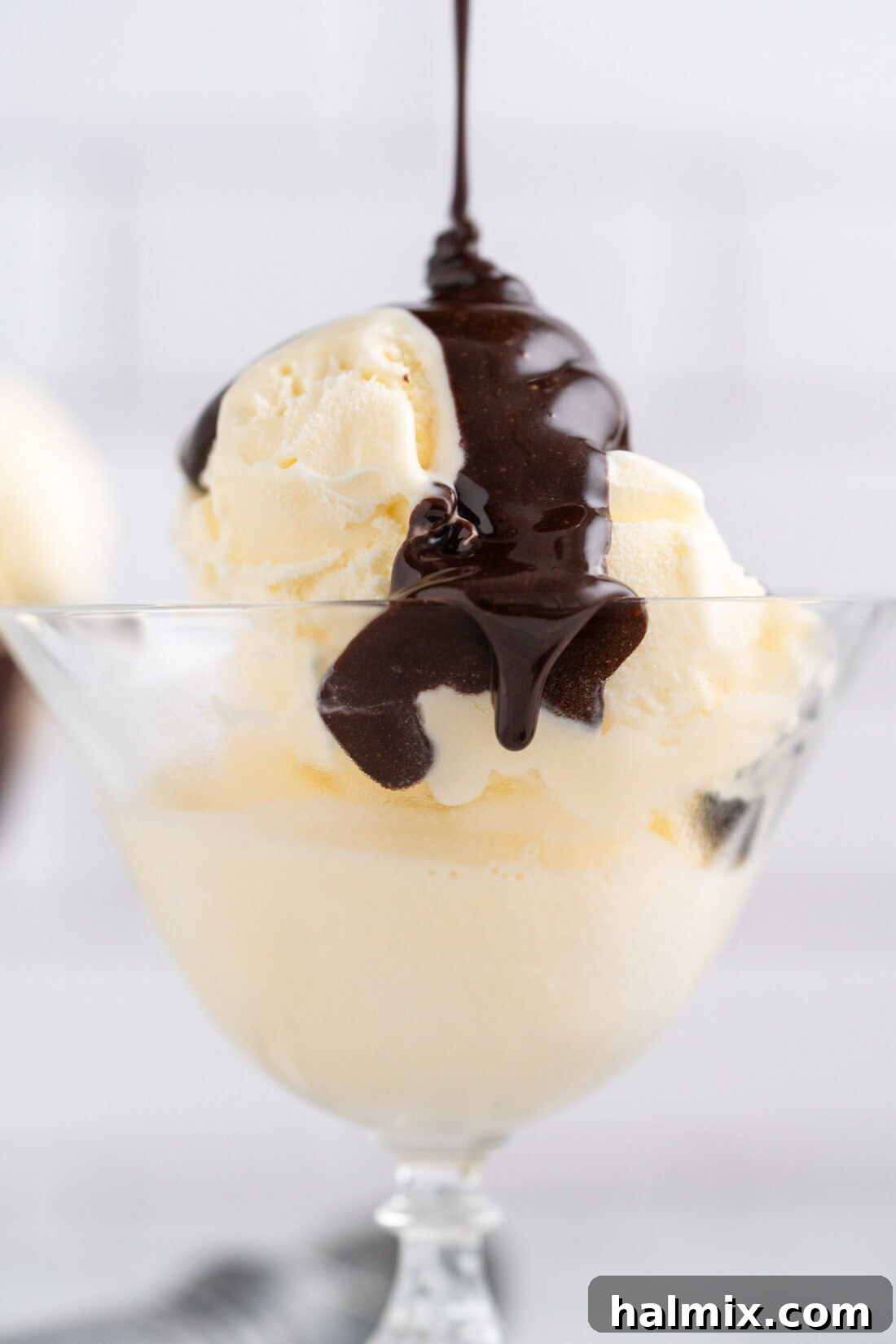 Warm Chocolate Indulgence 12 Hot Fudge being drizzled over ice cream