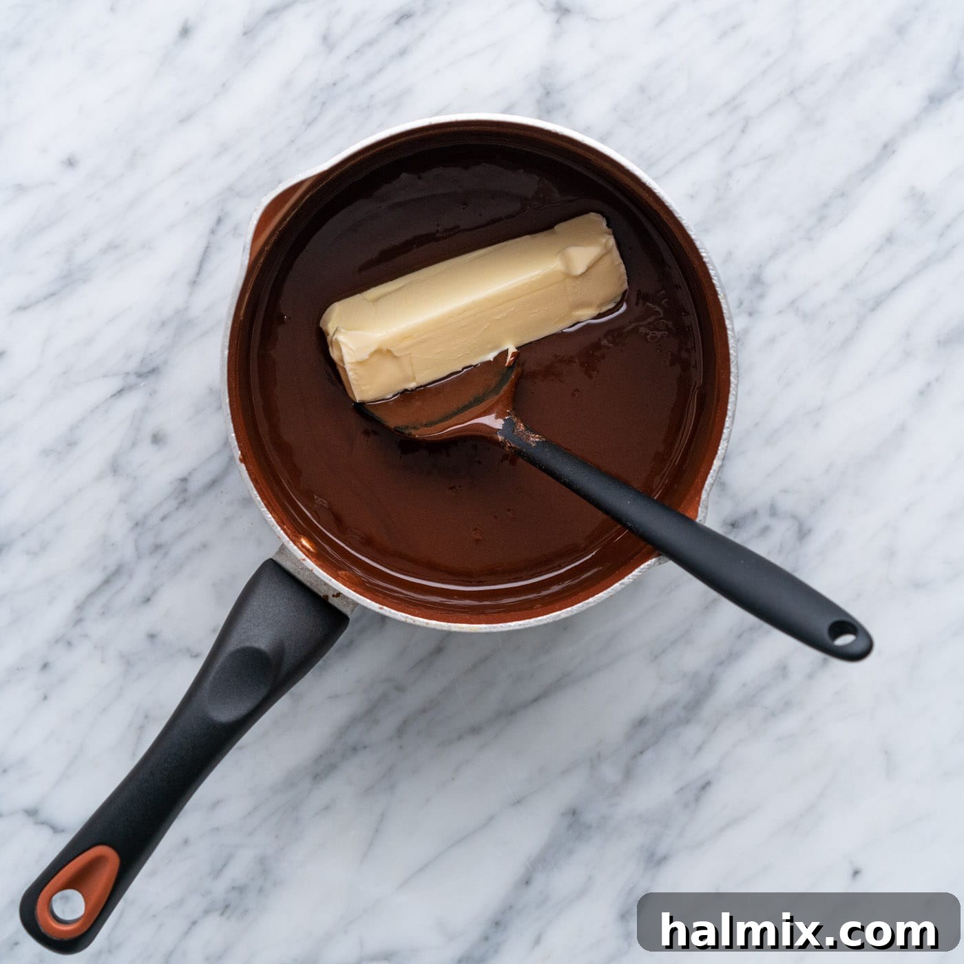 Warm Chocolate Indulgence 8 adding butter to hot fudge in a pot