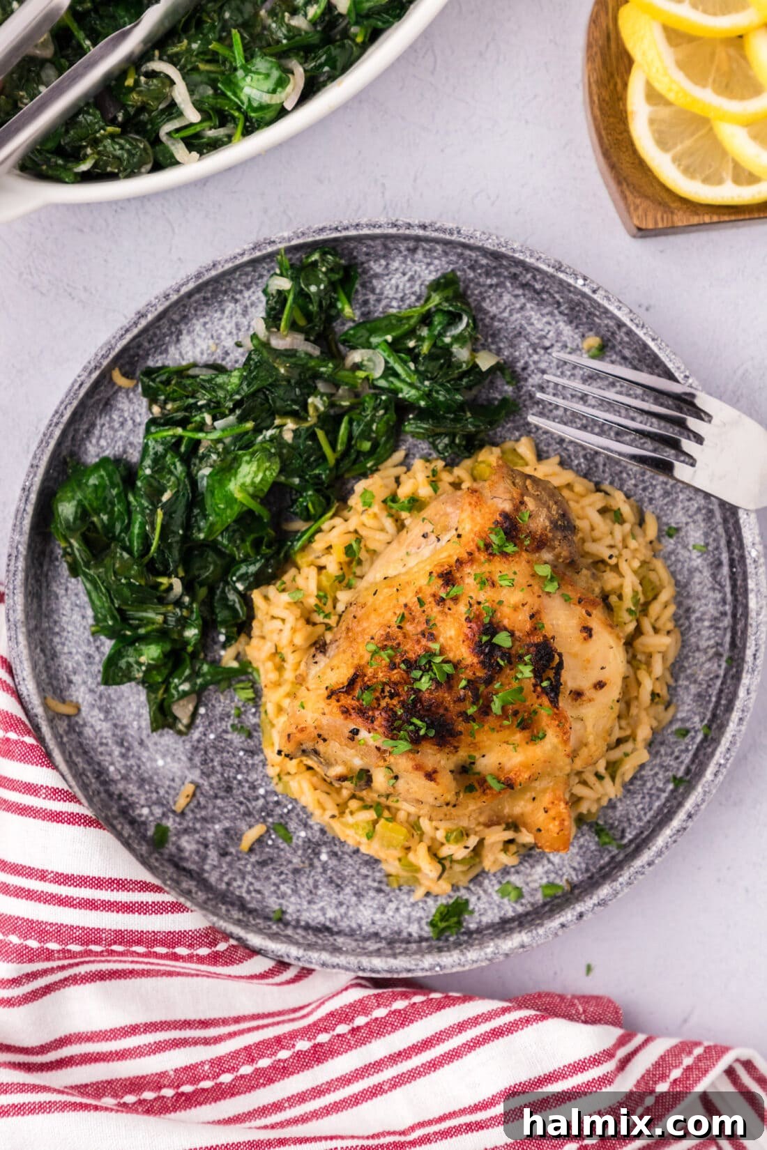 Instant Pot Chicken Thigh on a plate with sautéed spinach, perfectly browned and ready to eat.
