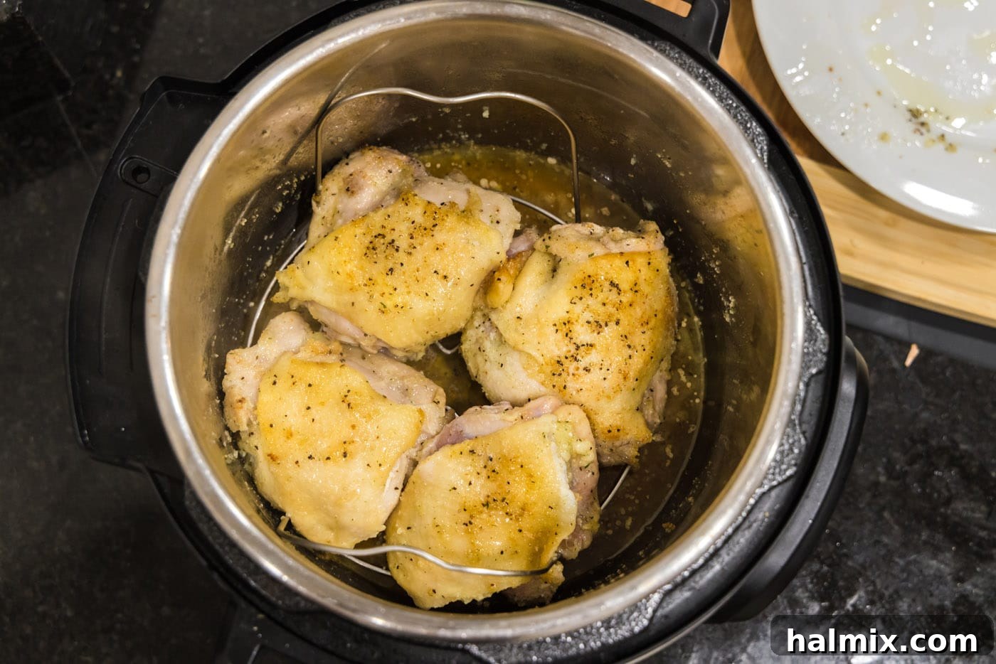 Chicken thighs carefully arranged on the Instant Pot trivet.