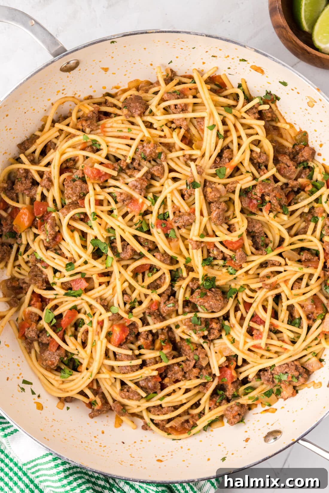 A vibrant skillet of Taco Spaghetti, ready to be served, showcasing the rich sauce and melted cheese.