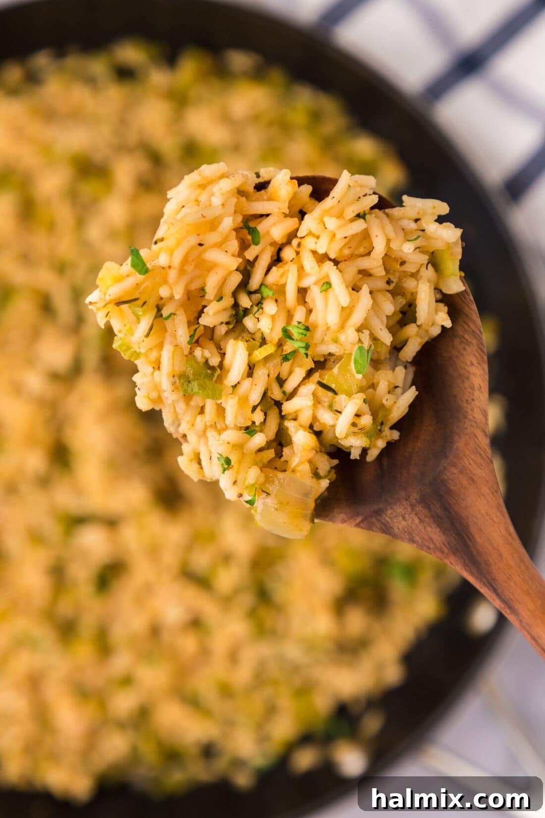 Spicy Southern Comfort Rice 2 A close-up view of fluffy, perfectly cooked Cajun Rice, rich with green bell pepper, onion, and celery, promising a burst of Southern flavor.