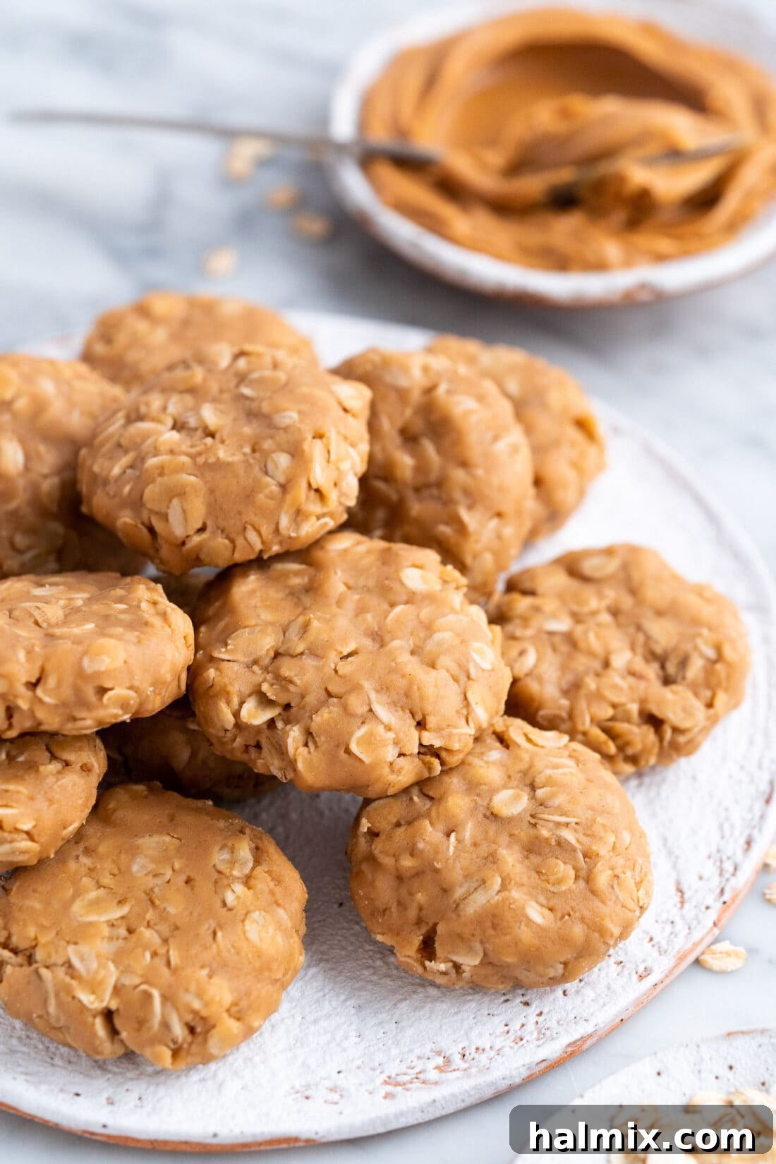 No Bake Peanut Butter Cookies on a plate with peanut butter in the background