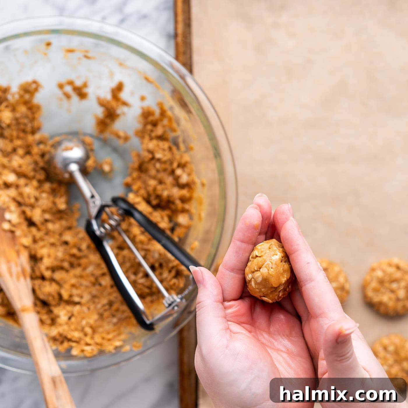 hands pressing dough ball to flatten