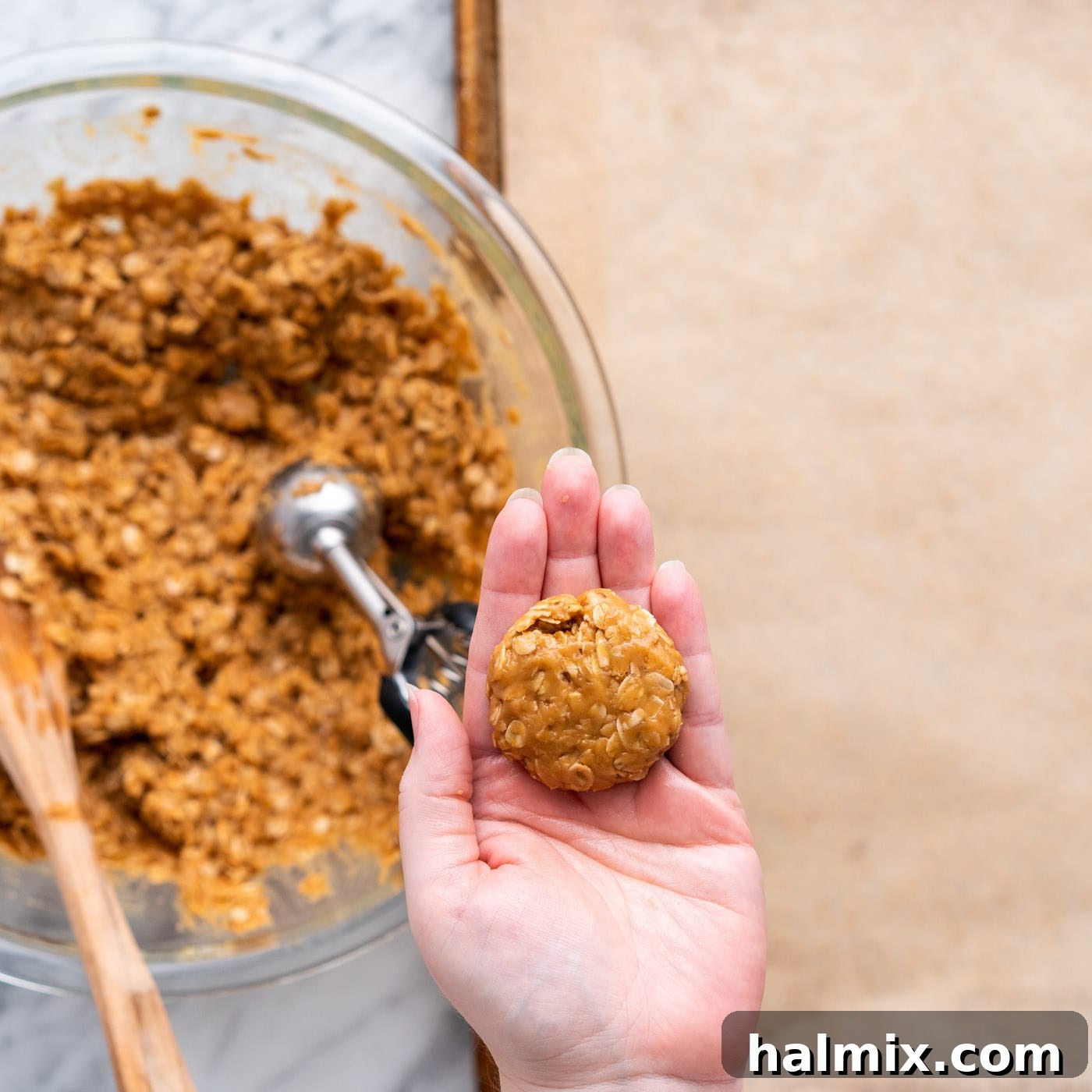 flattened peanut butter cookie dough ball in palm of hand
