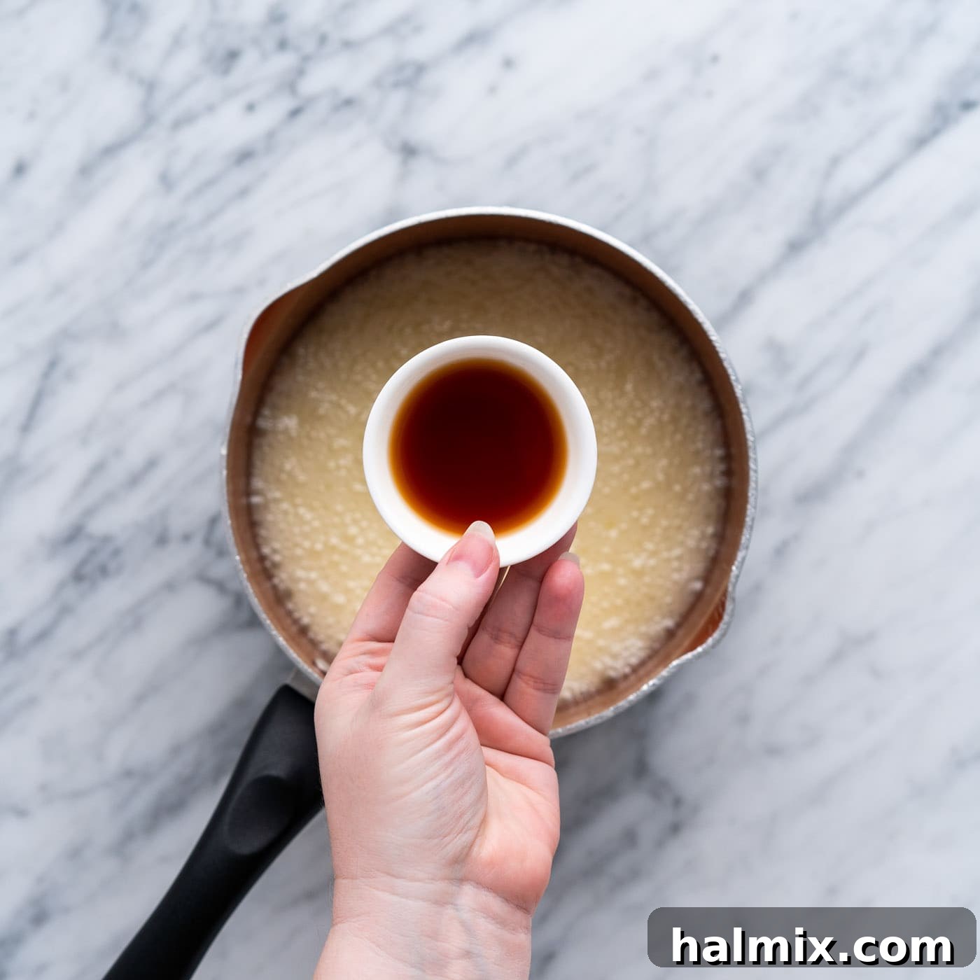 adding vanilla to saucepan with butter mixture