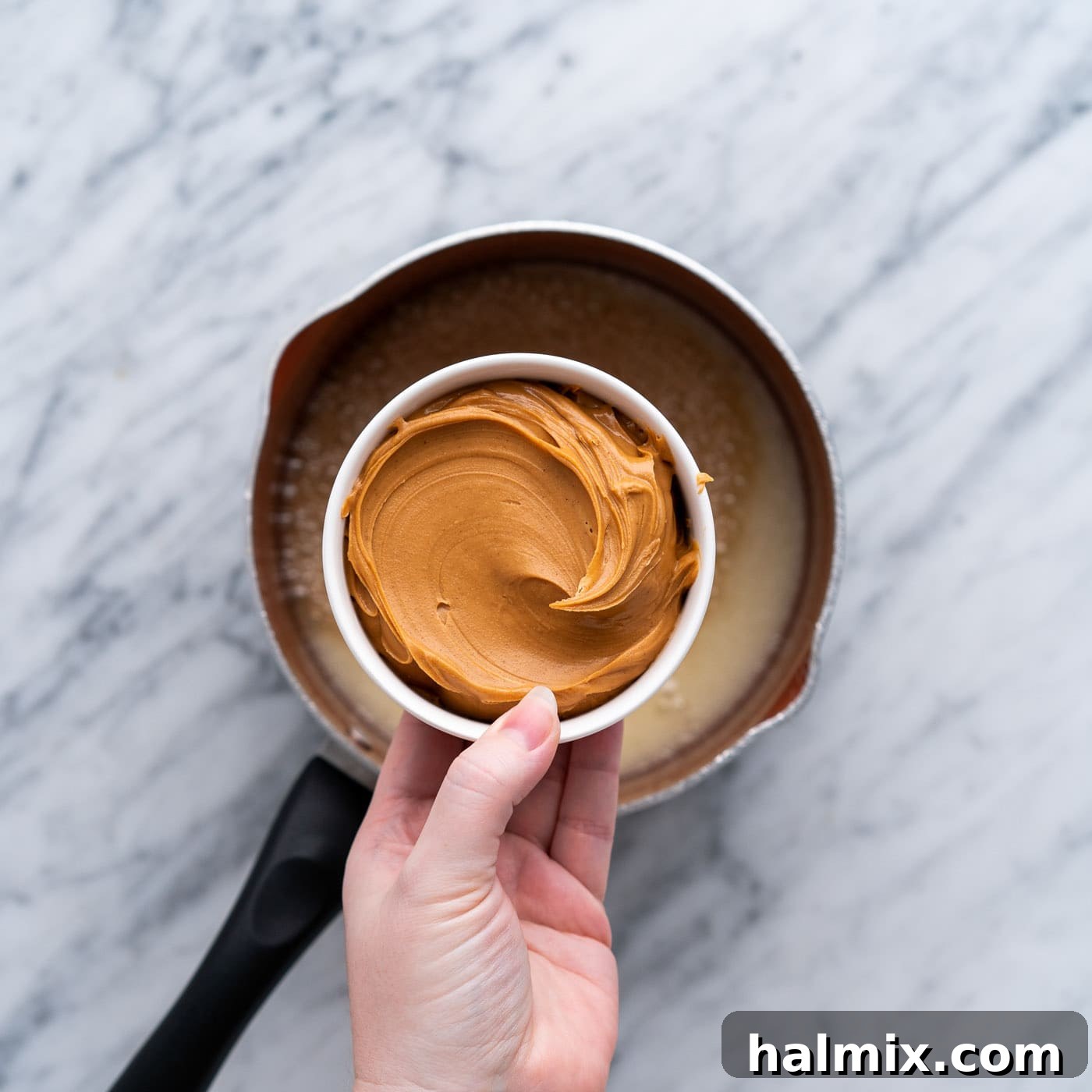 adding creamy peanut butter to butter mixture