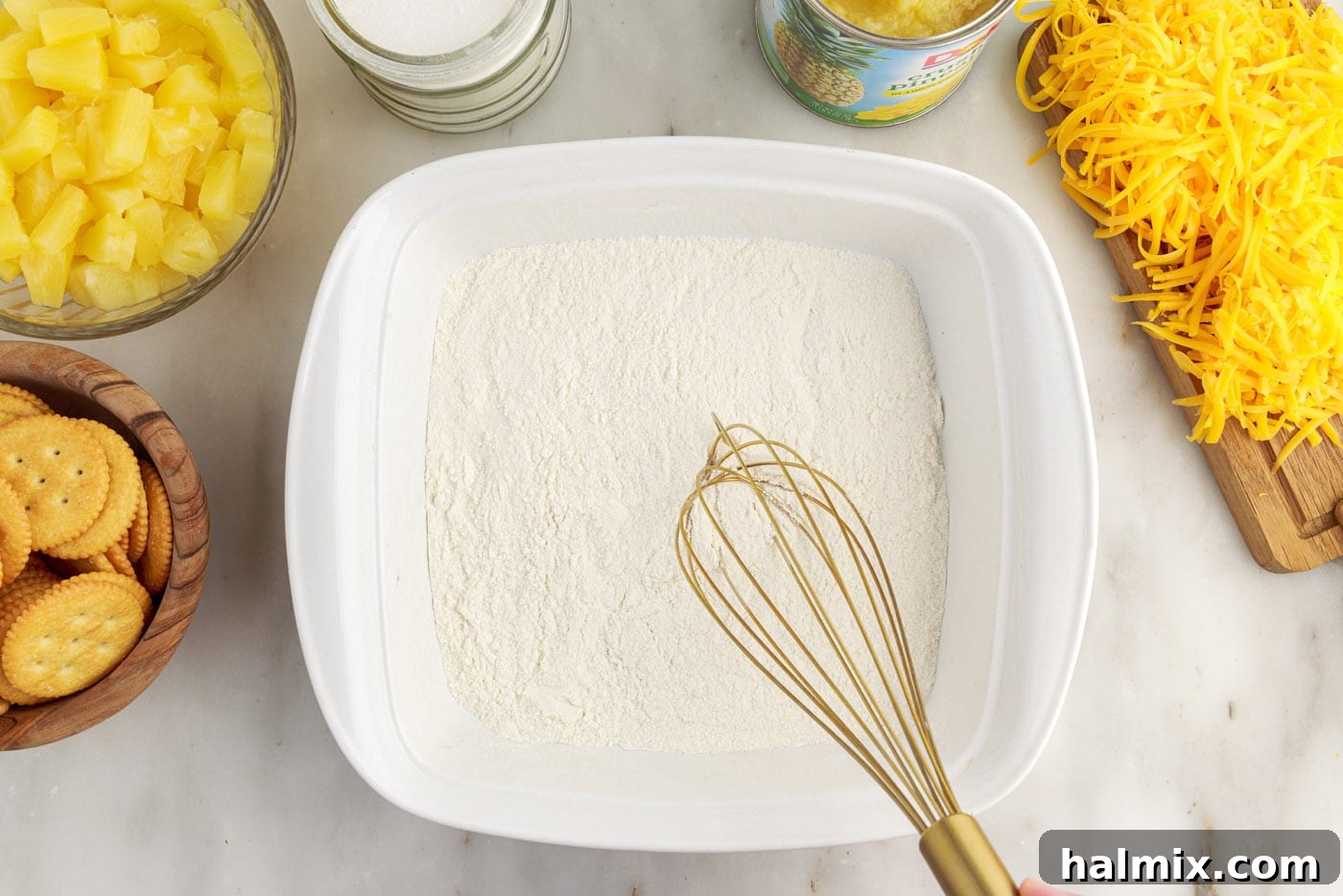 whisking flour and sugar in a baking dish