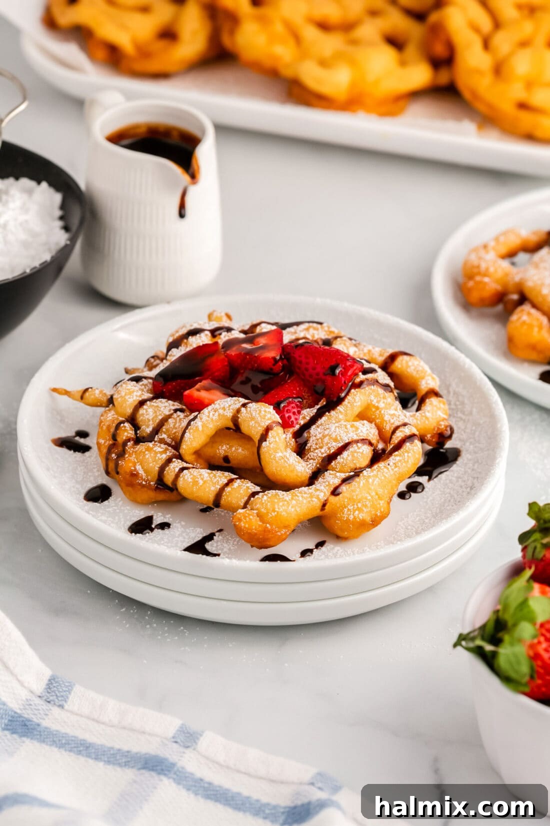 Golden Carnival Whirl 14 Funnel Cake topped with a delightful combination of powdered sugar, rich chocolate sauce, and fresh strawberries