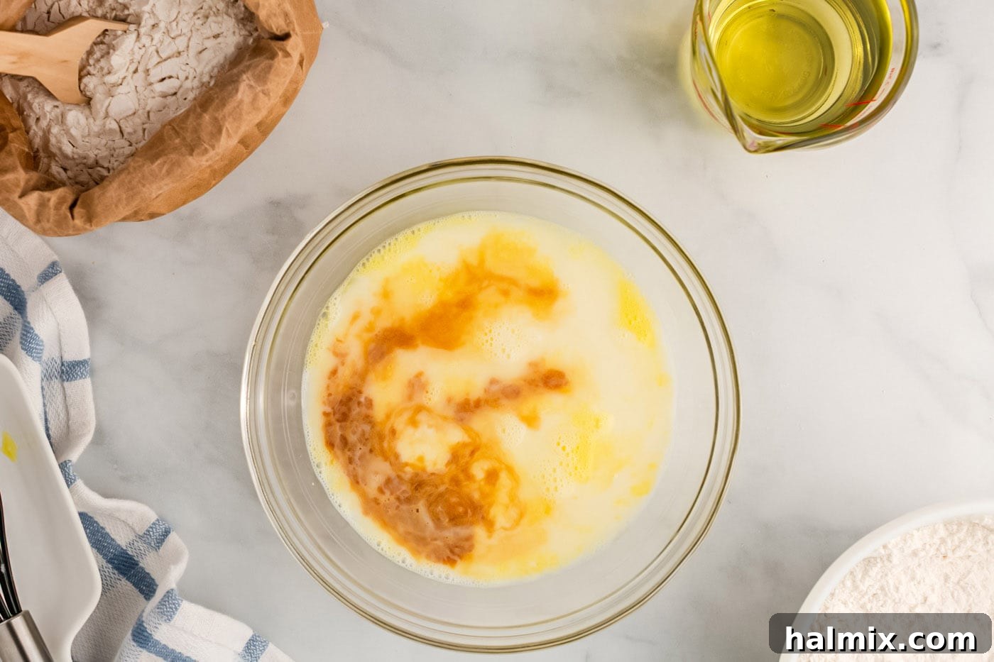 Golden Carnival Whirl 7 Egg, milk, water, and vanilla mixed in a bowl