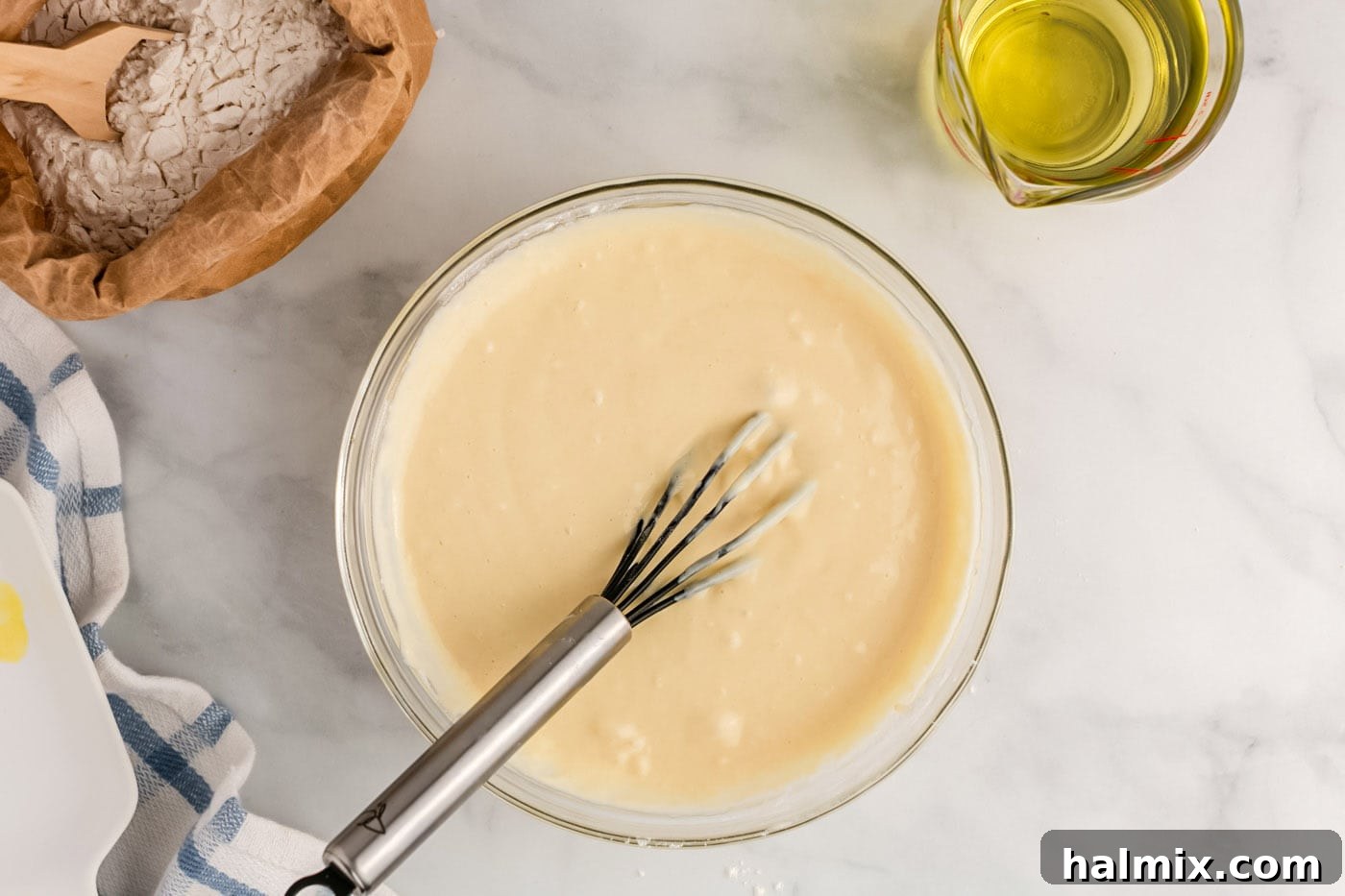 Golden Carnival Whirl 10 Whisked funnel cake batter in a bowl, showing the ideal consistency