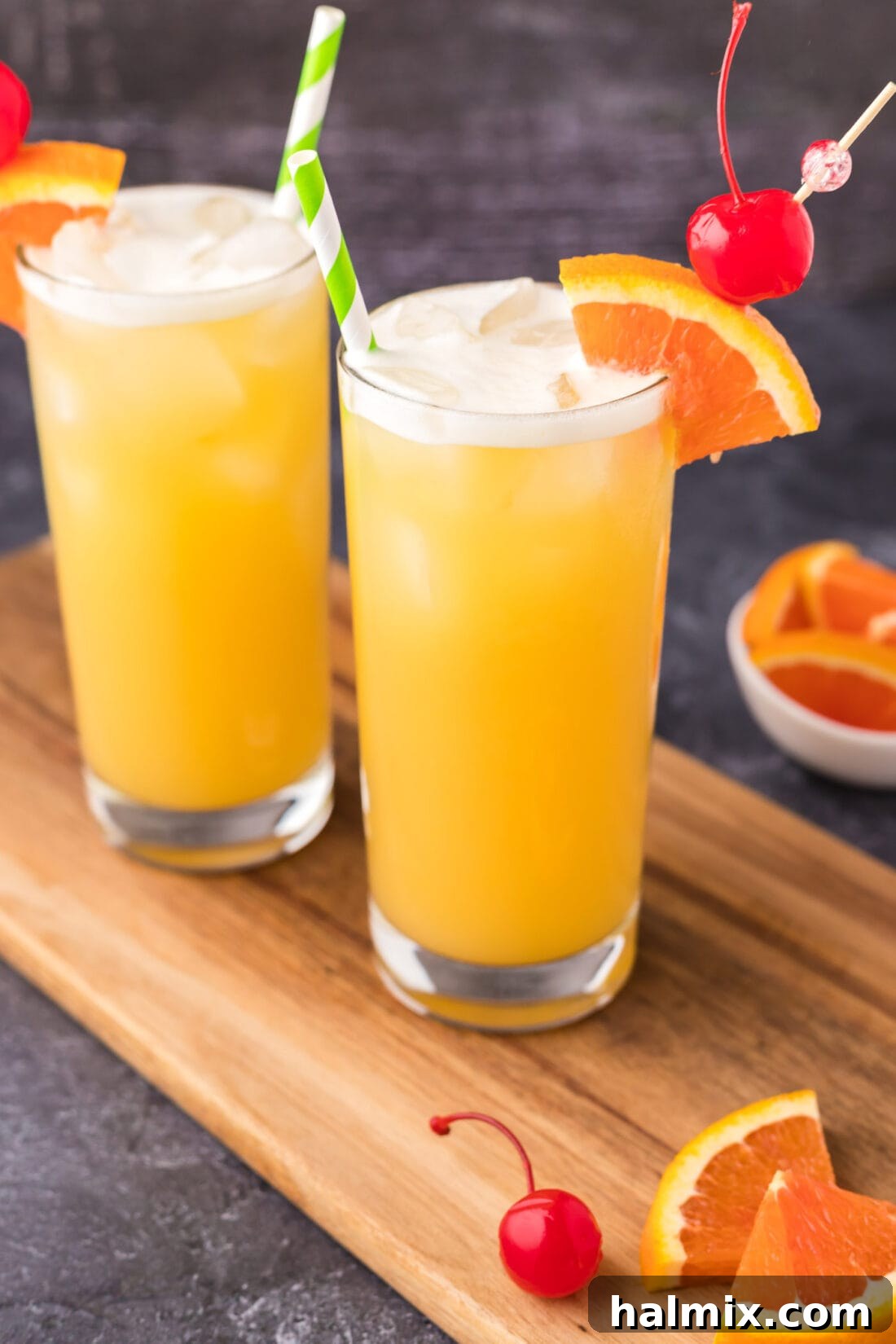 Two Skrew Loose Cocktails artfully placed on a wooden board, garnished and ready for serving.