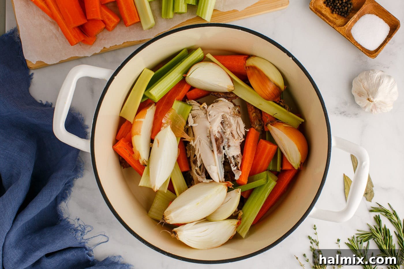 Chicken stock ingredients nestled in a stockpot before simmering.