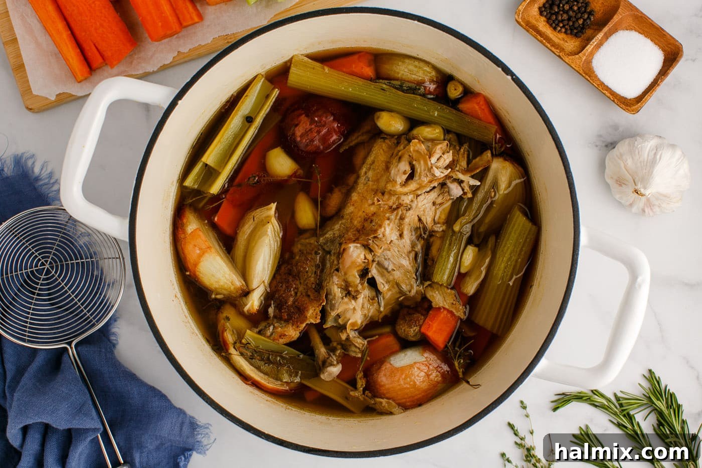 Homemade chicken stock gently simmering on the stovetop.