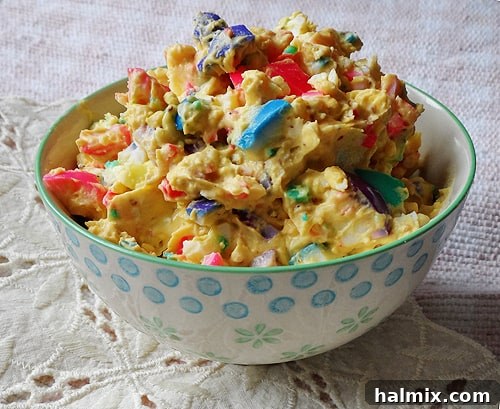 Rainbow Eggs: Two Ways to Delight 3 A close-up photo of a bowl filled with vibrant rainbow egg salad, showing chopped egg whites mixed with colorful yolk pieces, ready to be served.