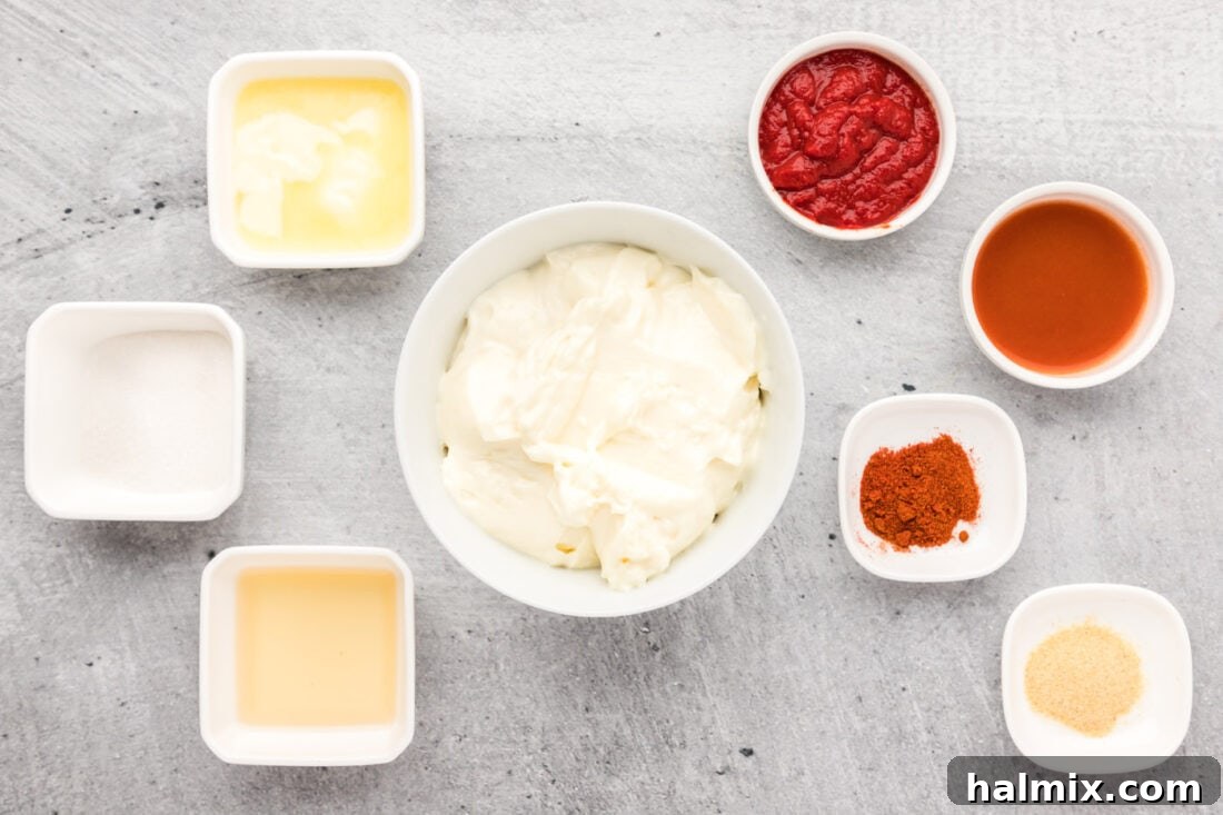 Individual ingredients for Yum Yum Sauce neatly laid out on a kitchen counter, ready for mixing.