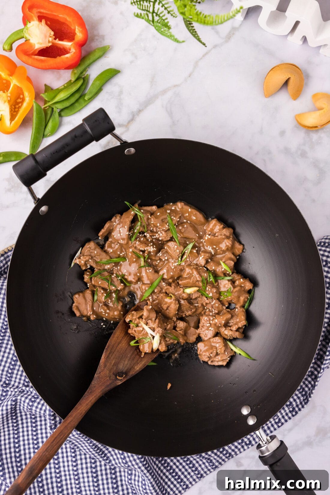 A wok of Beef Teriyaki with a spoon