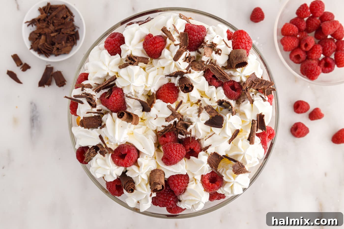 raspberry trifle garnished with fresh raspberries and curled chocolate