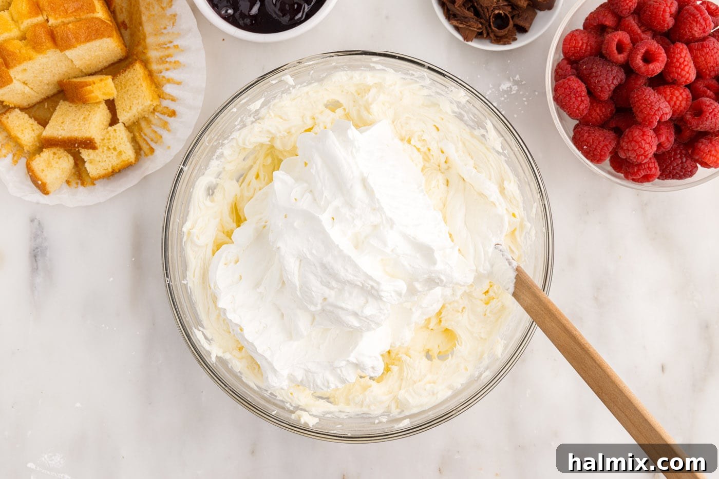 folding whipped cream into cream cheese mixture