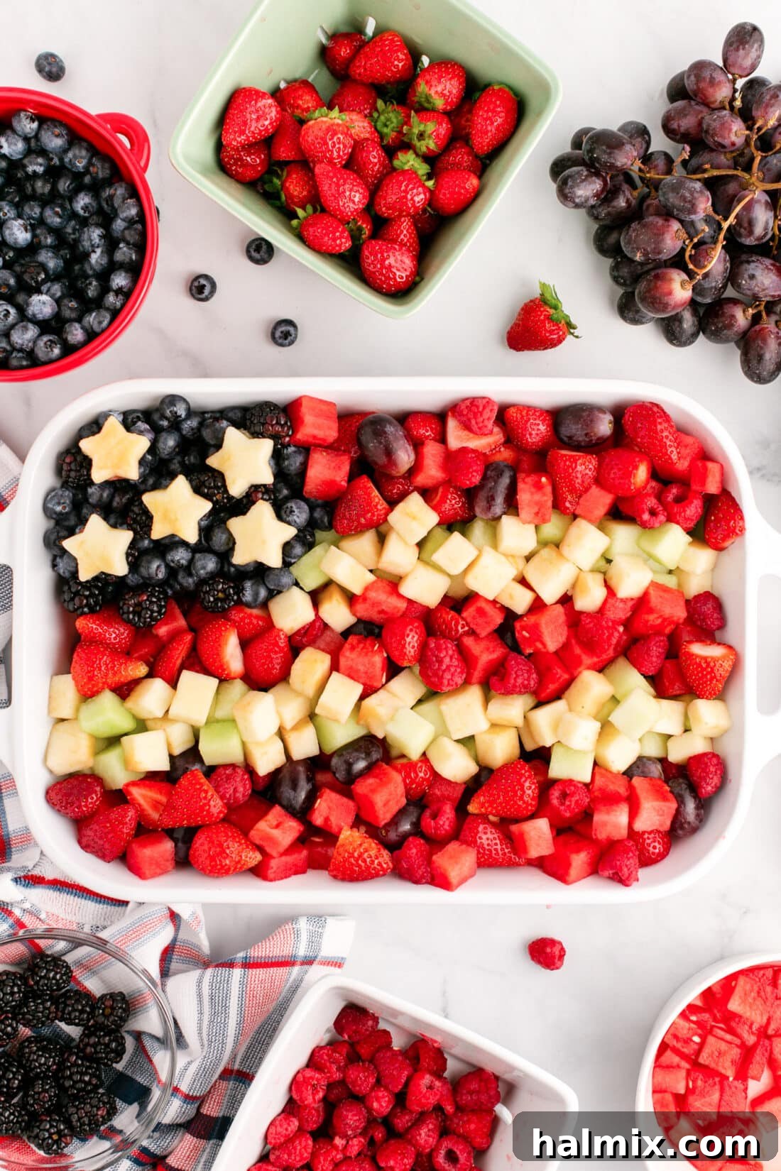 Red White & Blue Fruit Salad surrounded by fruit