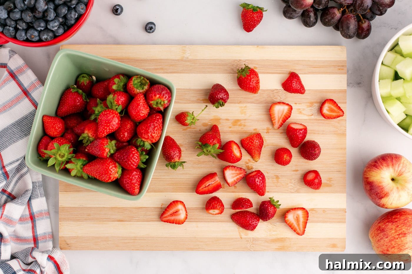 sliced strawberries on a cutting board