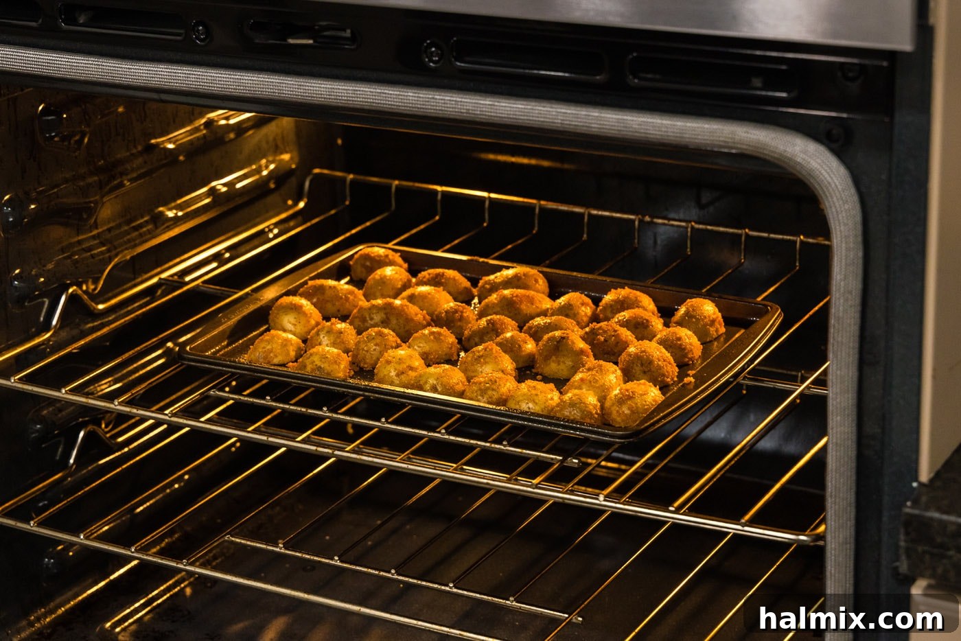 A closer view of the parmesan-coated potatoes on the baking sheet before baking