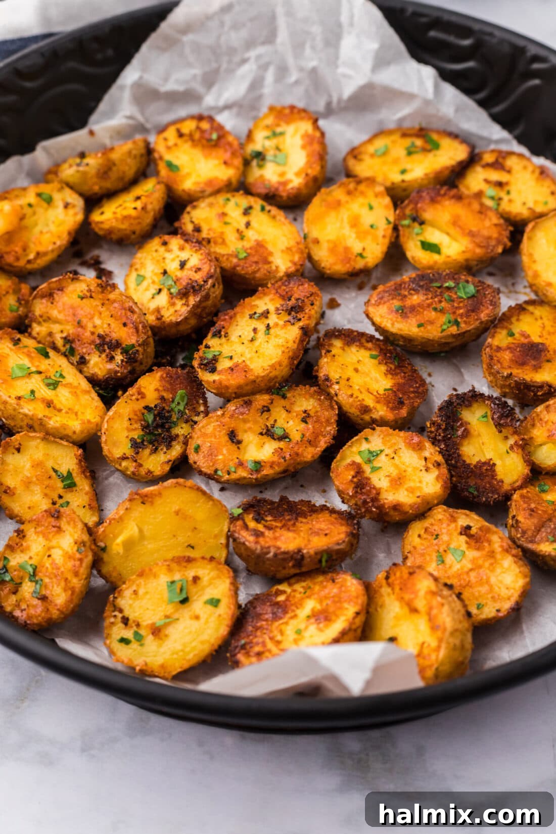 Close-up photo of a golden-brown parmesan potato wedge, showcasing its crispy texture