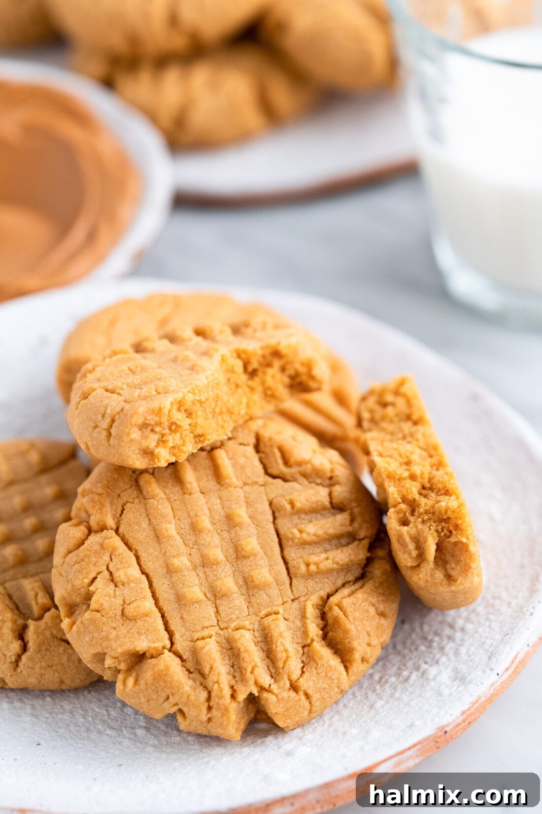 Peanut Butter Cake Mix Cookies on a plate with the top one broken in half