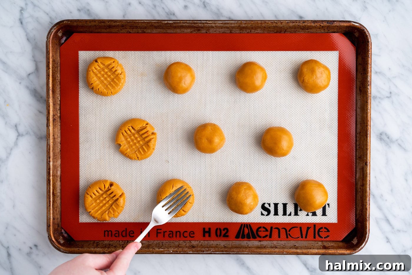 pressing peanut butter cookie dough with a fork