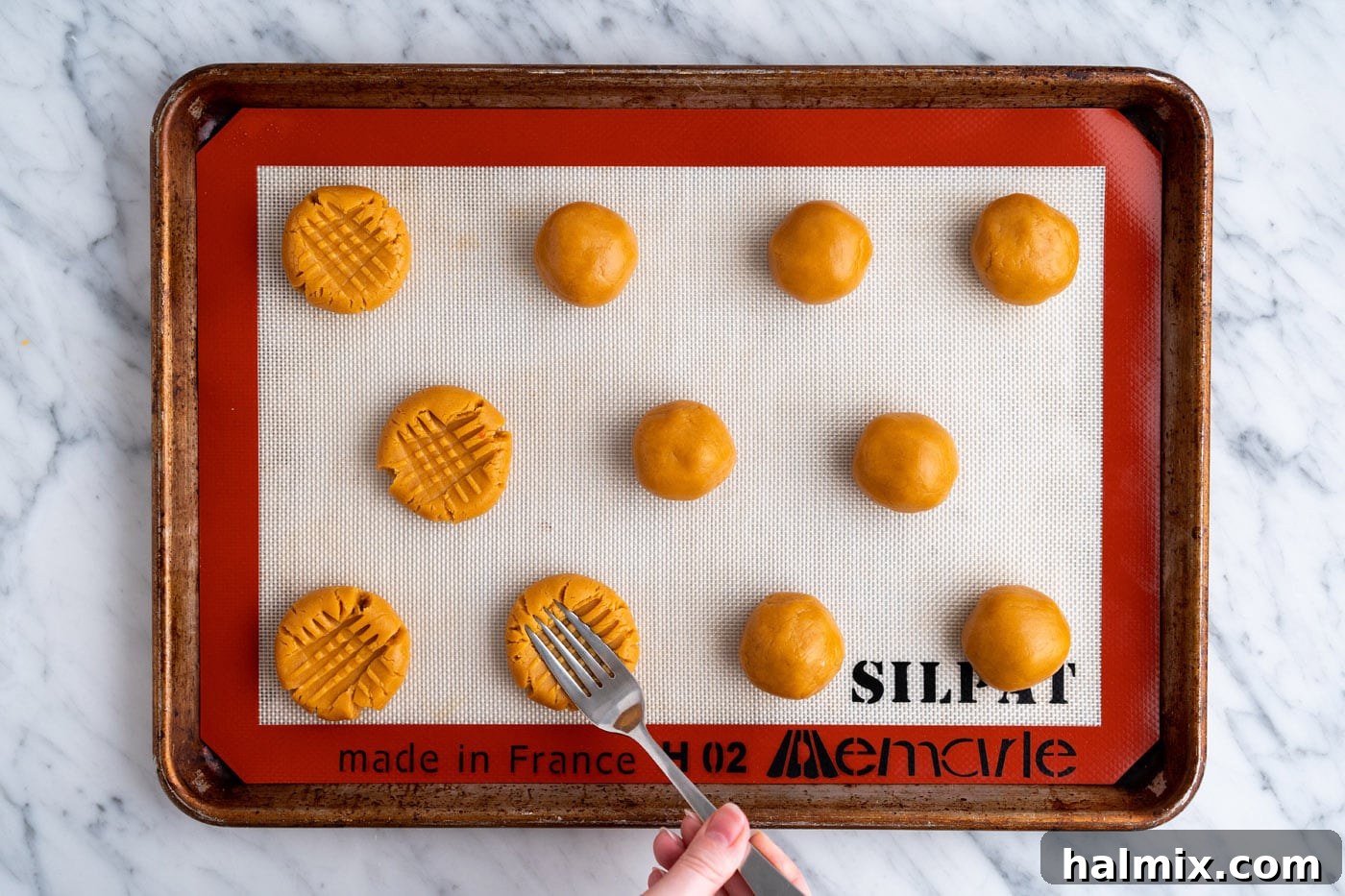 pressing dough balls with a fork