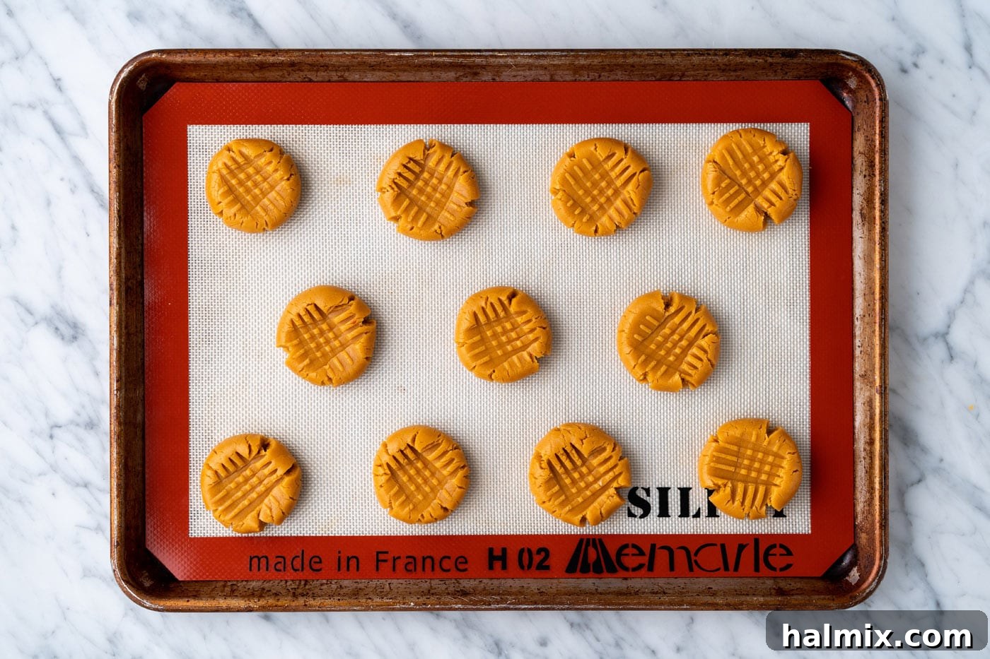 peanut butter cookie dough on a baking sheet