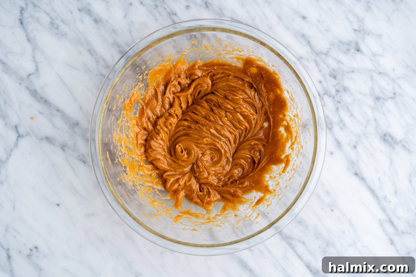 eggs, oil, and peanut butter mixed in a bowl