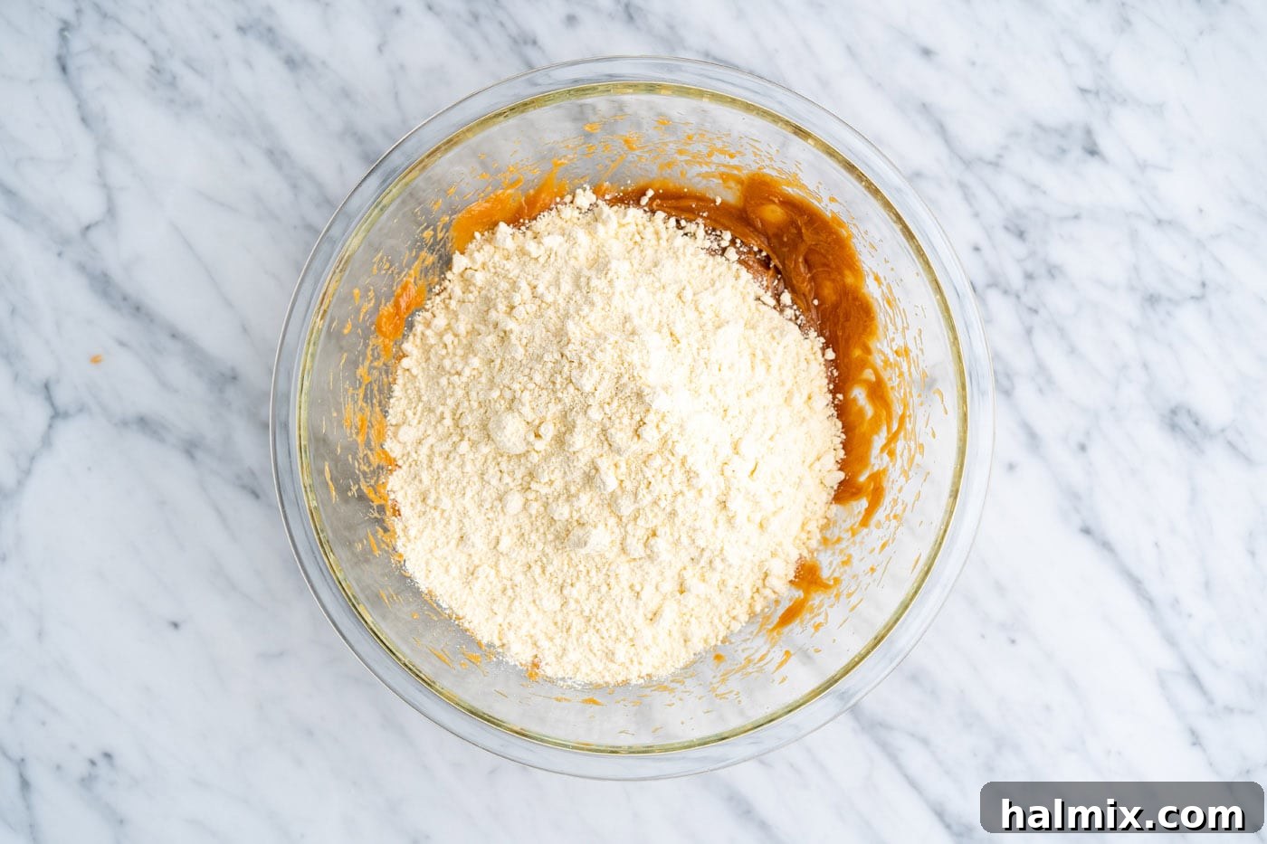 cake mix added to peanut butter mixture in a bowl