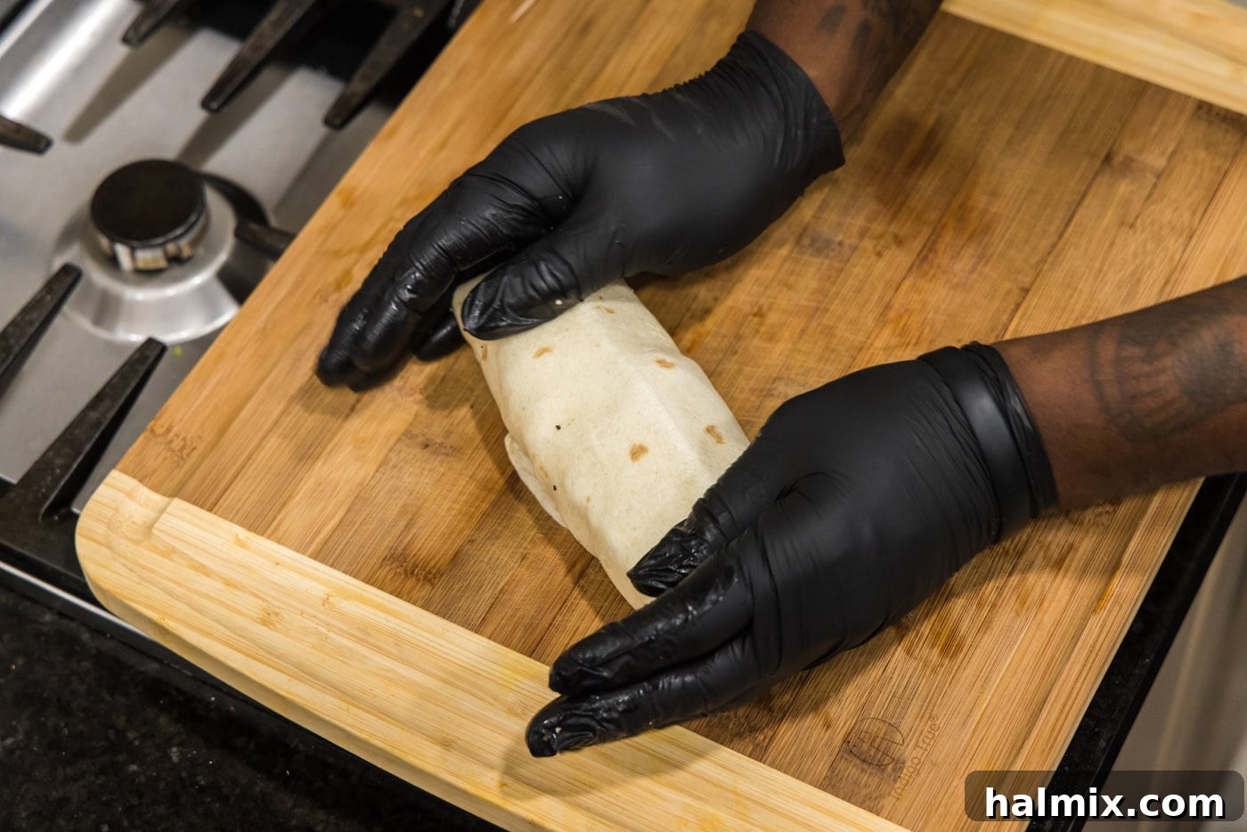 hands holding chicken bacon ranch wrap