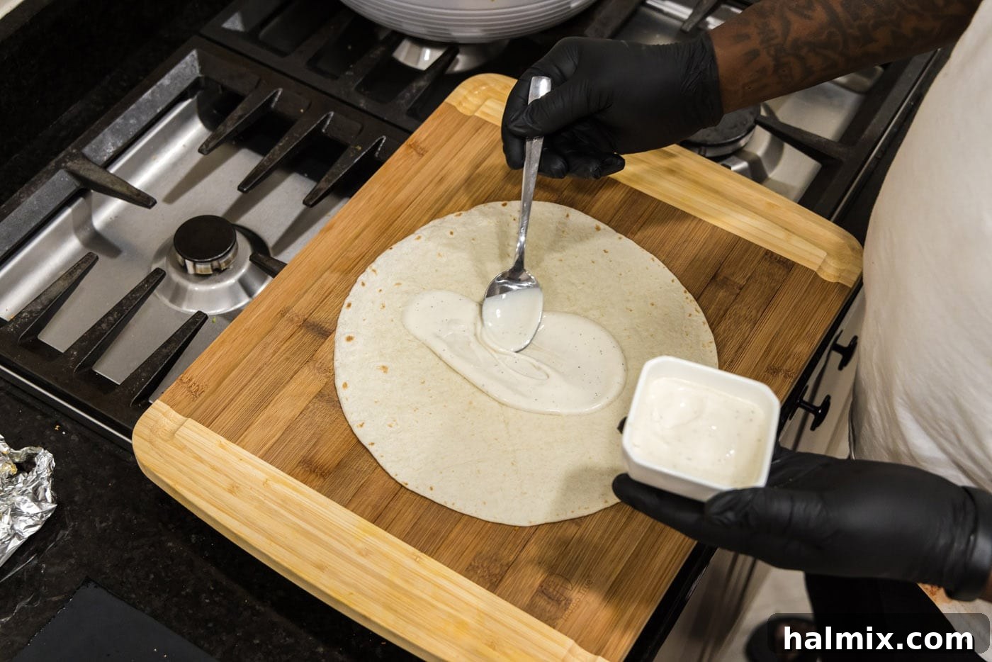 spreading ranch dressing onto tortilla
