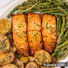 Close up photo of Brown Sugar Salmon served on a platter with garlic green beans and melting potatoes