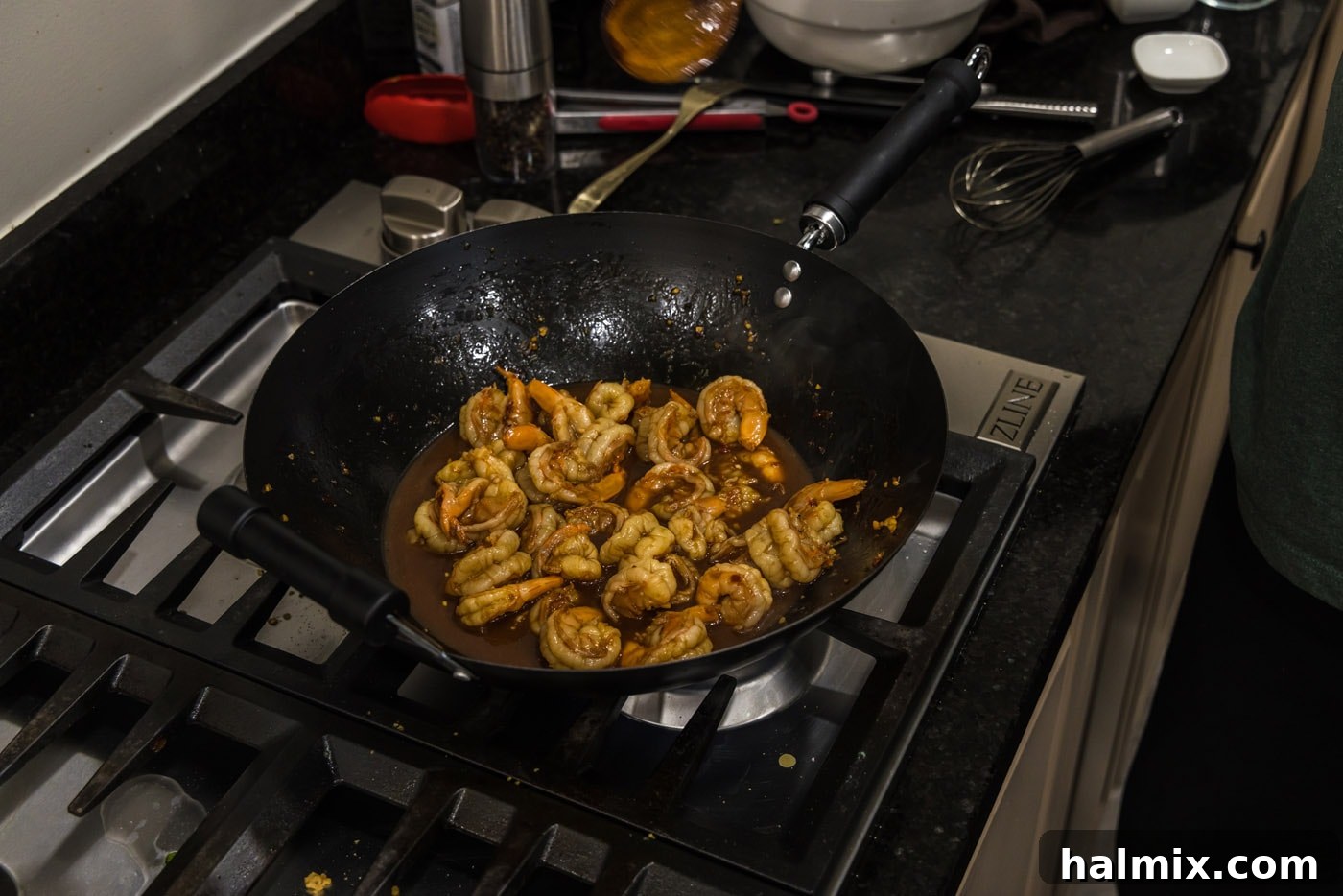 Hunan shrimp simmering in the wok, with the sauce thickening to a perfect consistency.