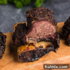 Close up photo of a Smoked Beef Short Rib, showing its tender meat and dark crust.