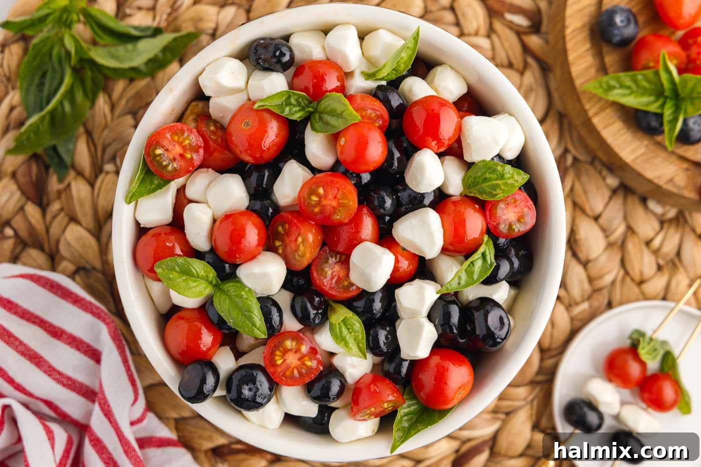 blueberries, mozzarella pearls, cherry tomatoes, and basil in a bowl