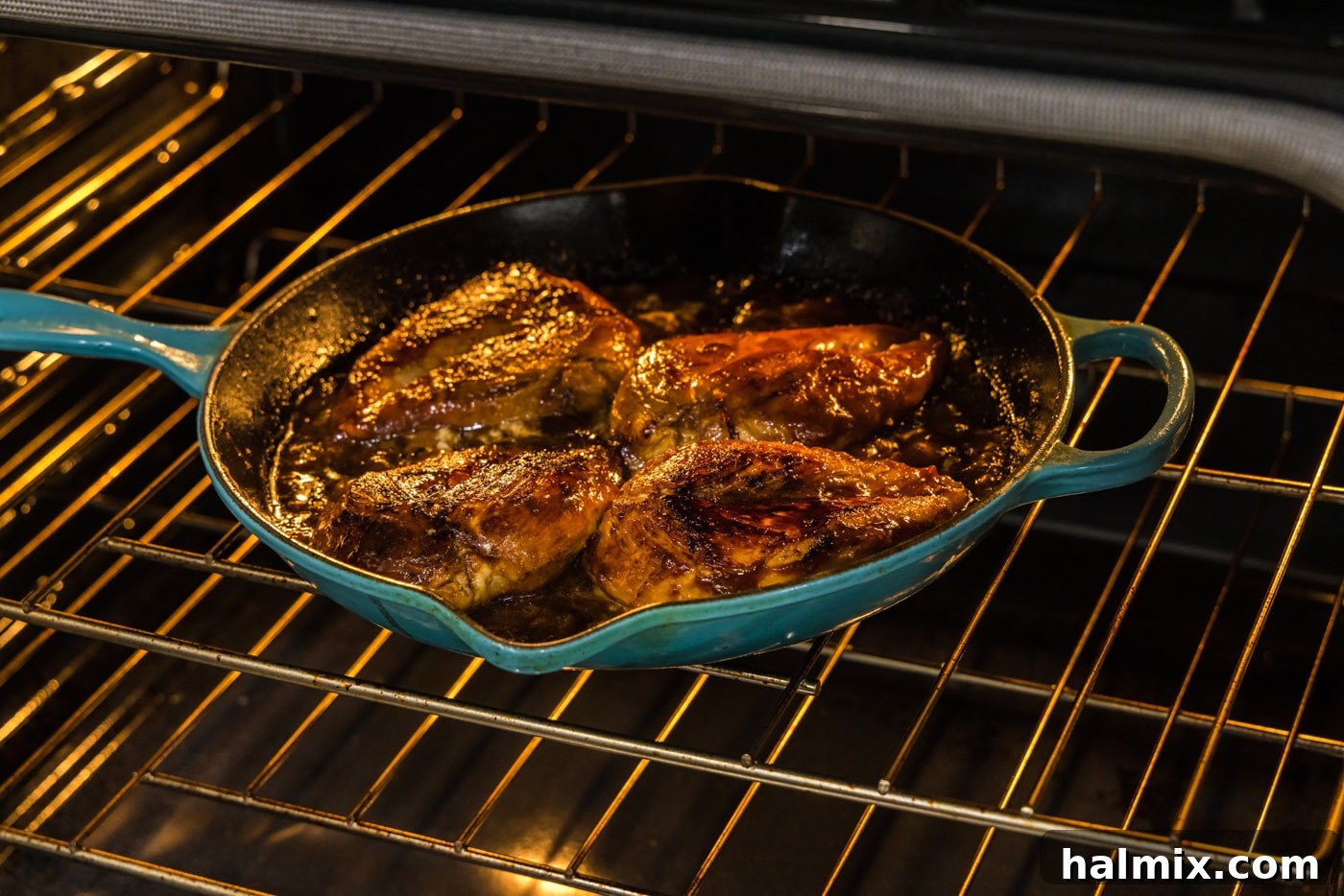 Honey garlic chicken breast baking in an oven-safe skillet.