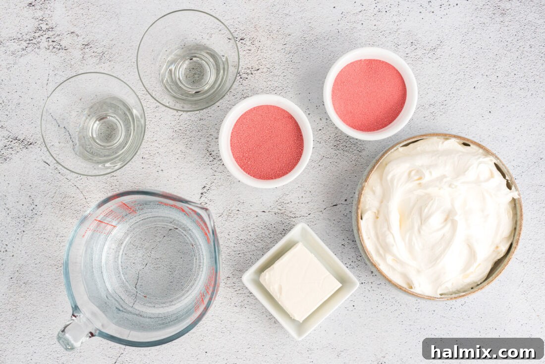 Ruby Raspberry Cream Stacks 4 A flat lay of Raspberry Jell-O Parfaits ingredients: jello boxes, cream cheese, cool whip, and raspberries