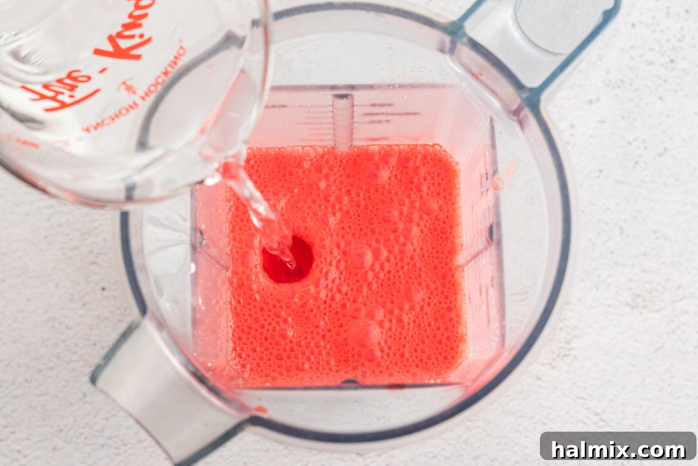 Ruby Raspberry Cream Stacks 9 adding cold water to jello and cream cheese mixture in a blender