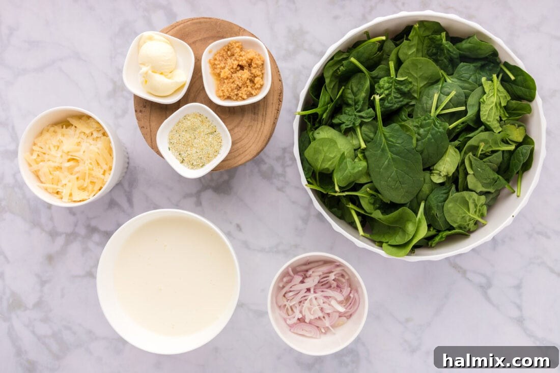 Ingredients for Creamed Spinach laid out on a cutting board