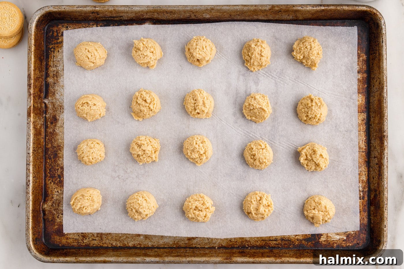 placing dough balls onto a parchment lined baking sheet
