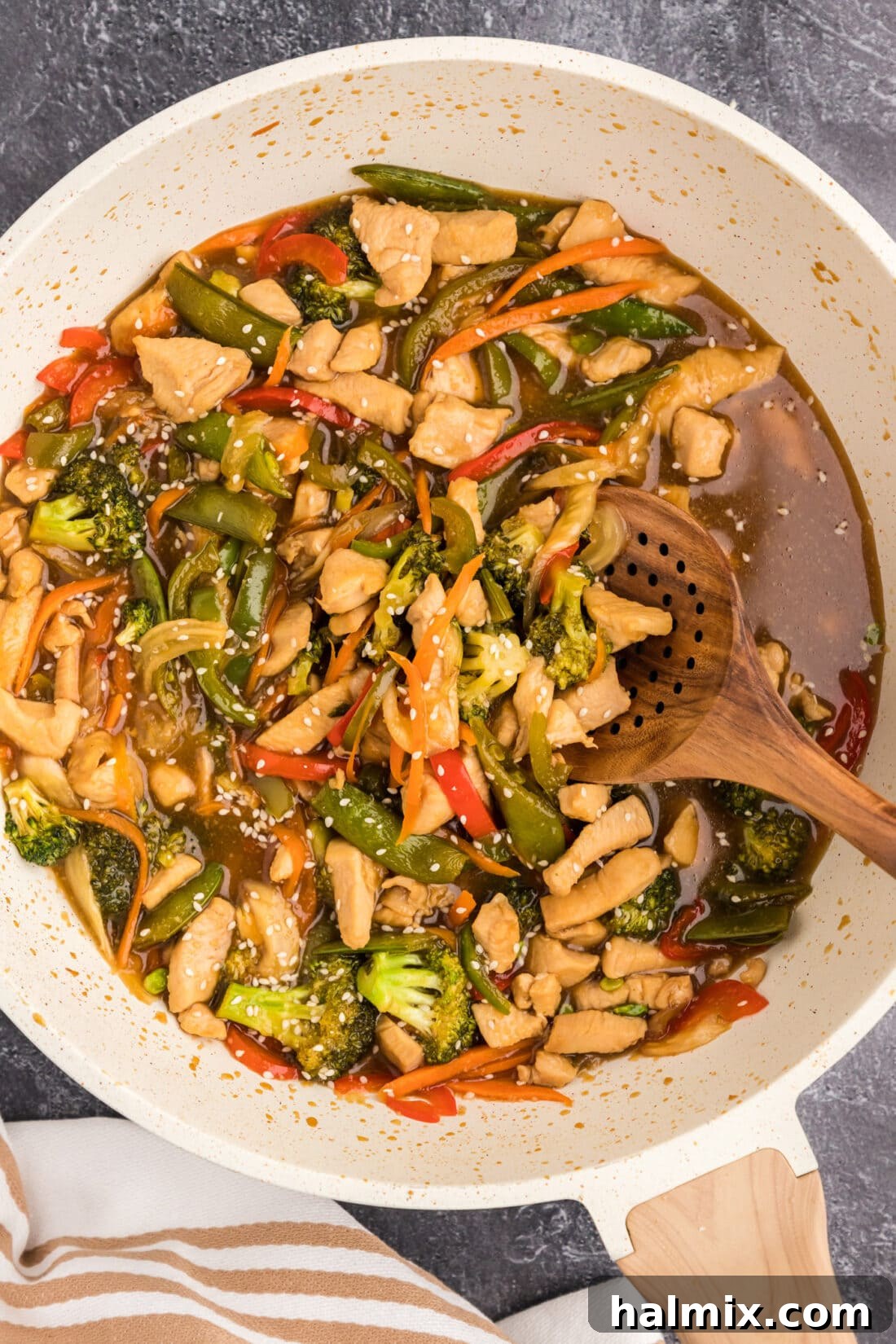 Skillet of Honey Garlic Chicken Stir Fry with a spoon in it