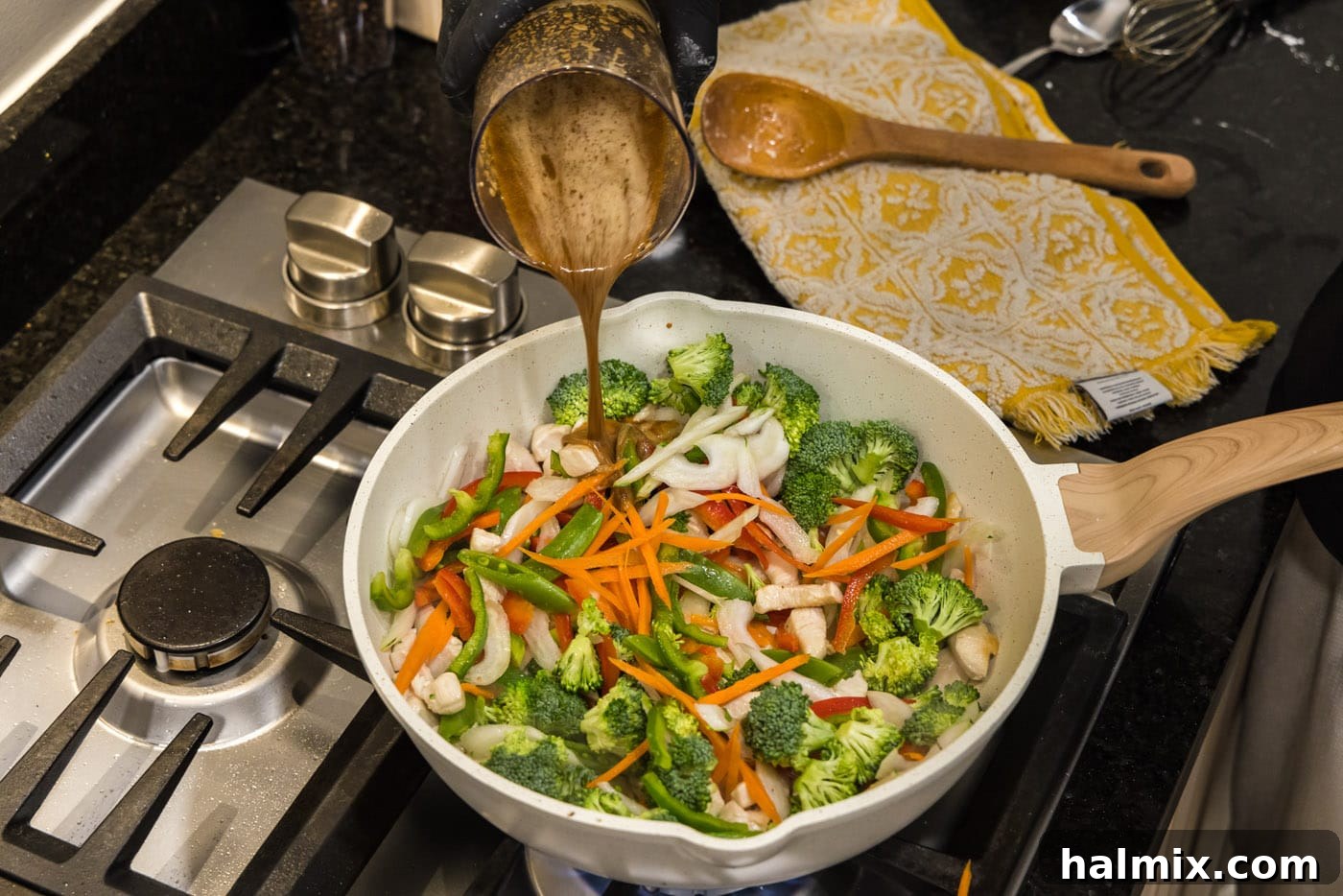 pouring sauce into stir fry skillet