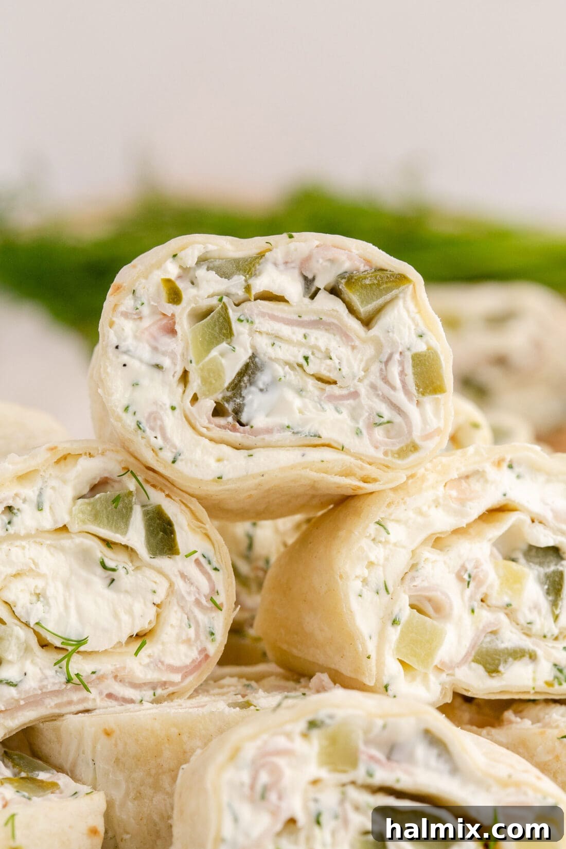 Close up photo of Dill Pickle Pinwheels stacked on top of each other
